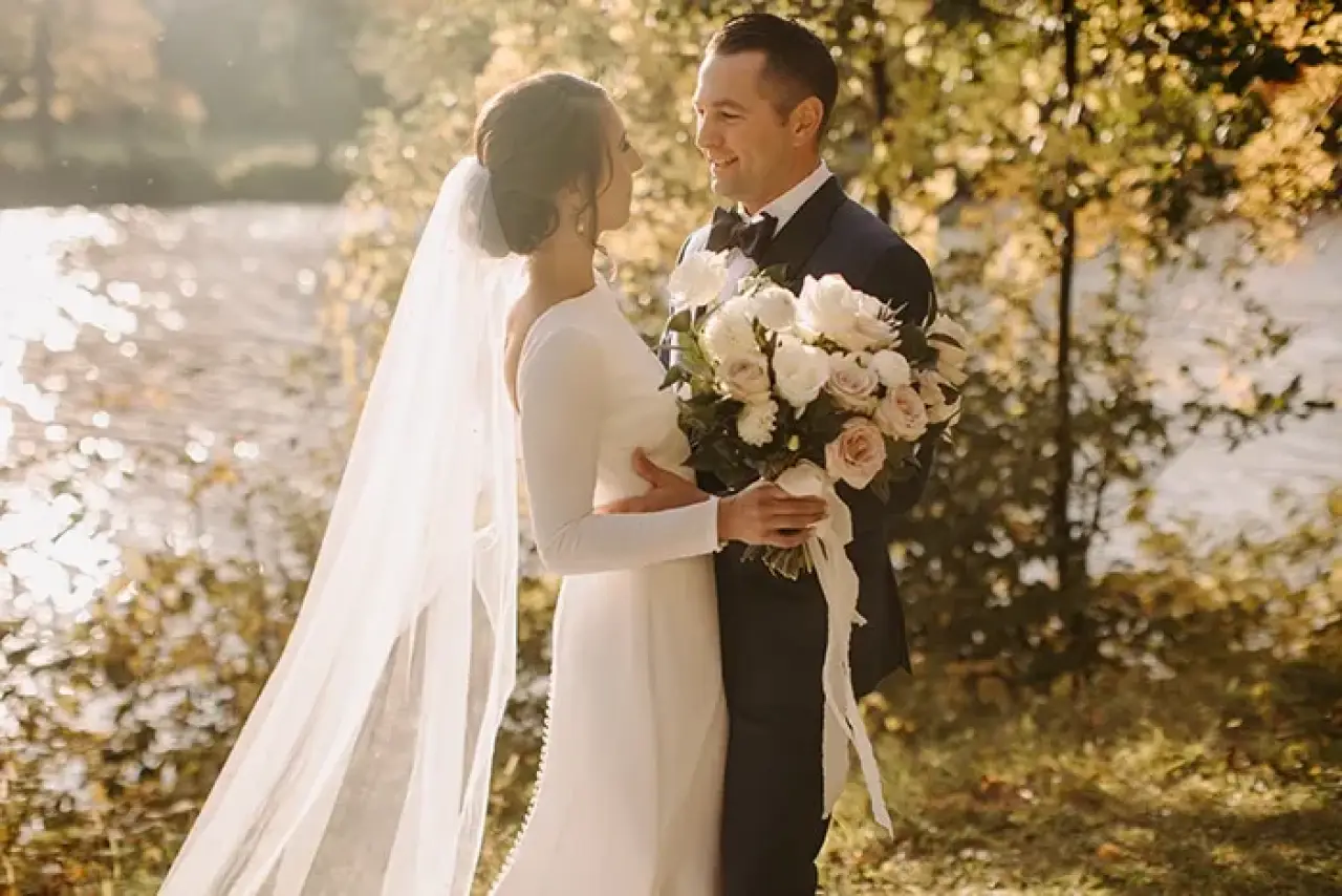 Happy couple on their wedding day wearing Adrian Jules custom suits