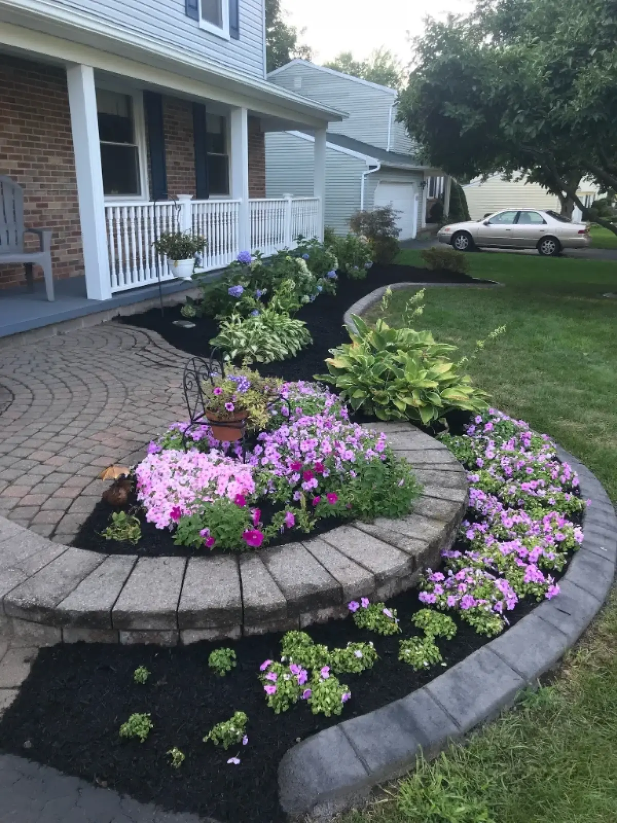 fresh flowers and mulch on home walkway