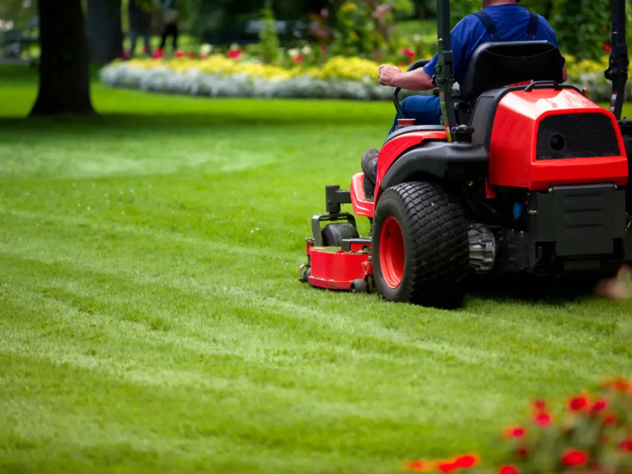 man mowing a lawn with commercial lawn equipment