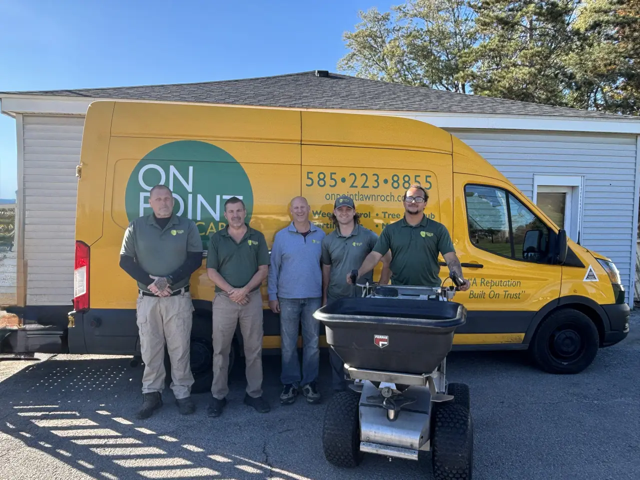 The OnPoint Lawncare team standing together. From left to right: Sean, Mike, David, Brian, and Max.