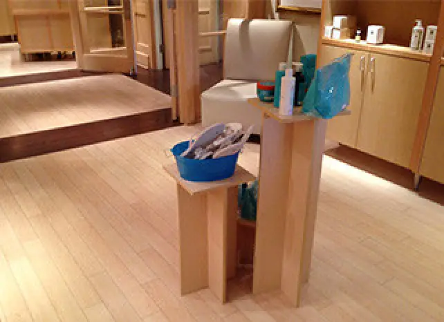 light brown wood floor and cabinets with cleaning supplies