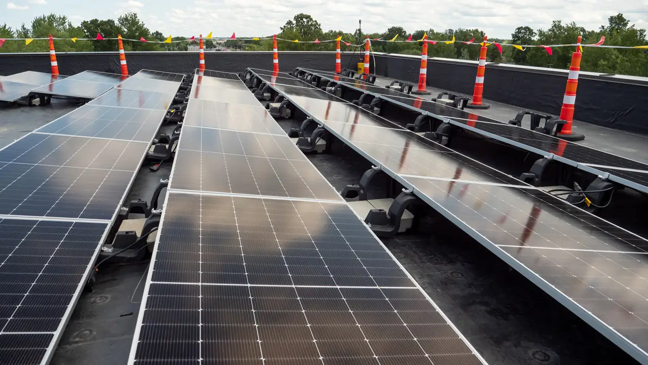 Rows of solar panels installed on a flat commercial rooftop.