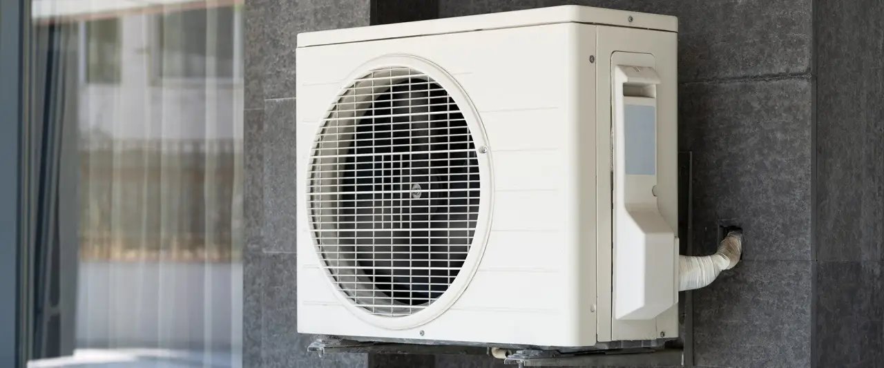 Ductless mini-split outdoor unit mounted on an exterior wall