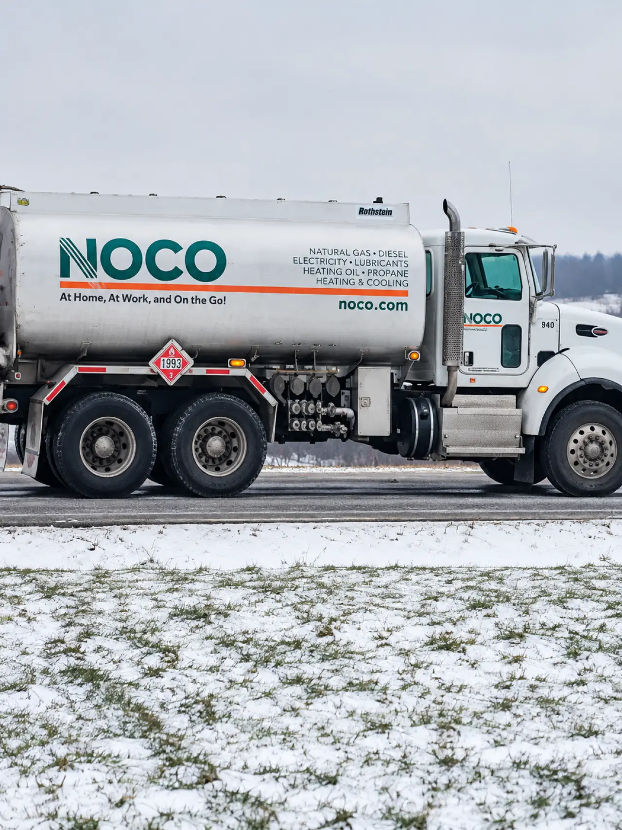 NOCO team member reviewing energy plans at a desk
