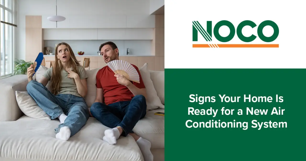 A man and woman on a couch look hot, using a fan and paper, with text about air conditioning.