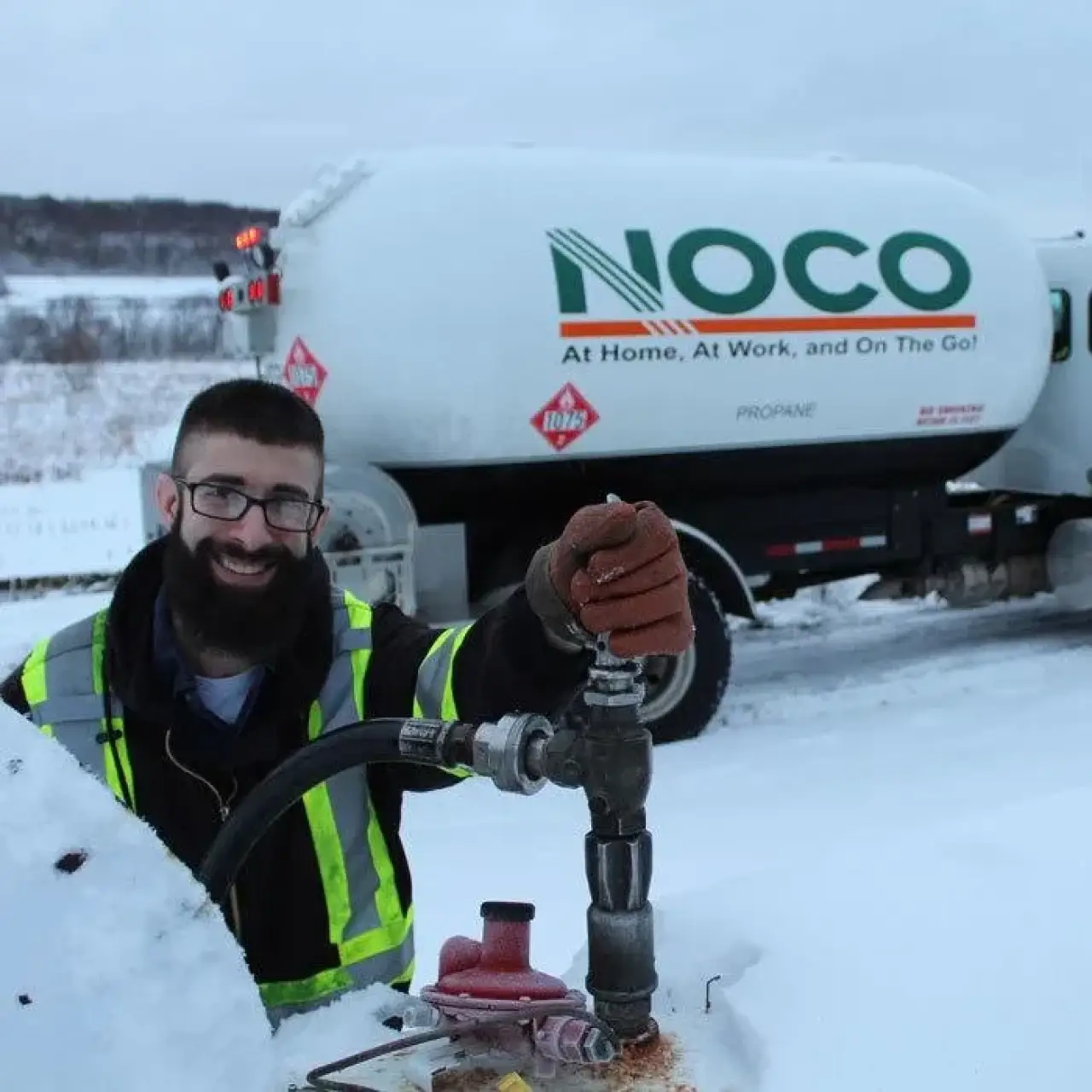 NOCO service technicians next to a company truck