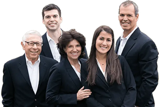 Five people in business attire standing together and smiling against a plain background.