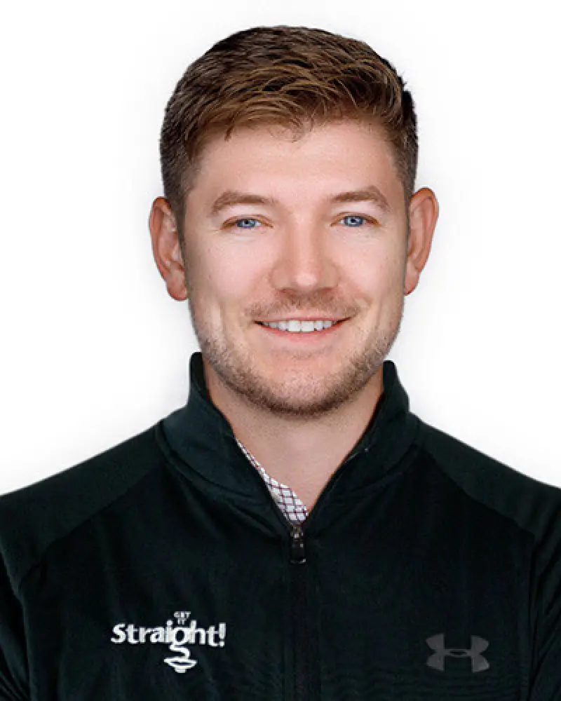 Smiling man in a black zip-up jacket with Straight and Under Armour logos on it.