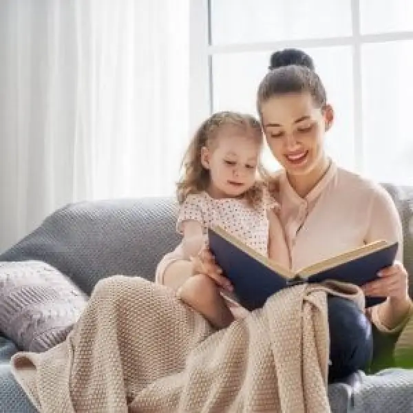 A mom reading to her daughter