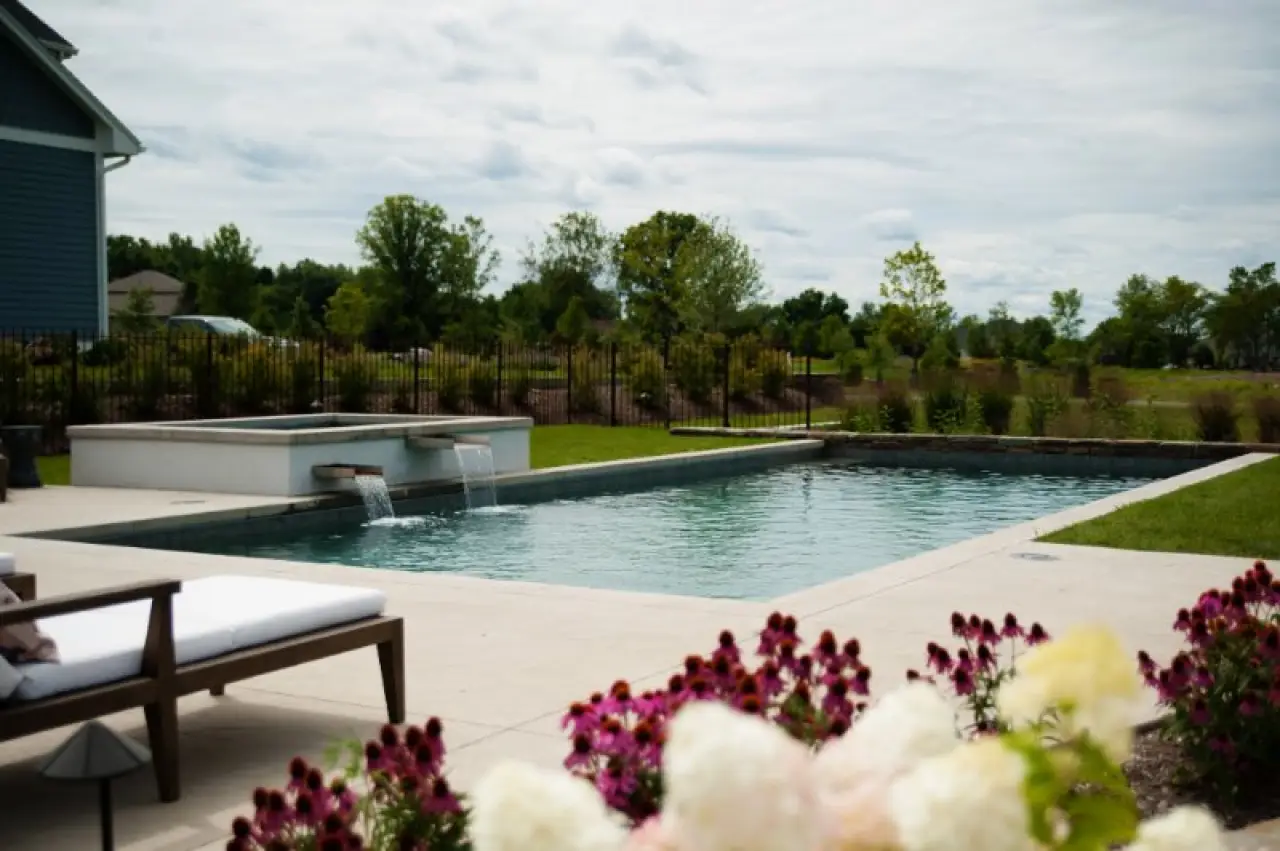beautiful angular pool with flower in foreground and a hot tub
