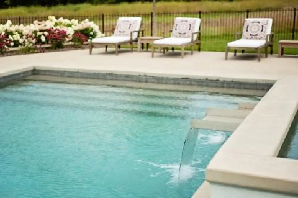 swimming pool and lounge chairs on the pool deck