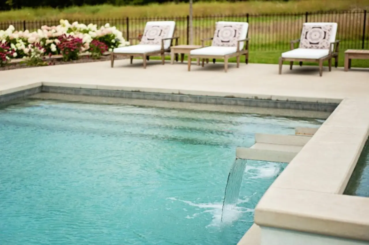 close up of steps into the pool with waterfall feature