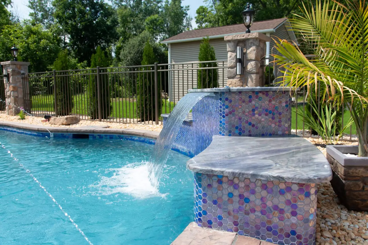 swimming pool with a decorative waterfall feature