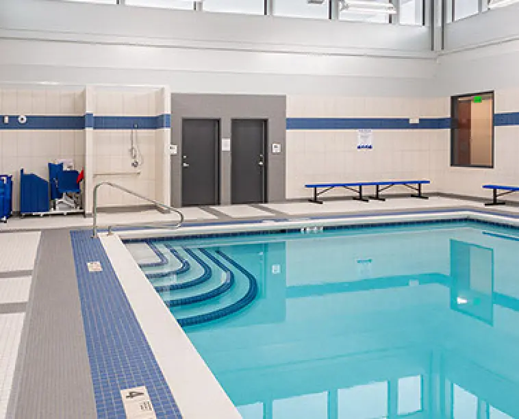 steps leading down into a indoor commercial pool