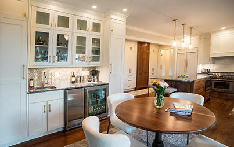 cozy bar area with white chairs at a round table