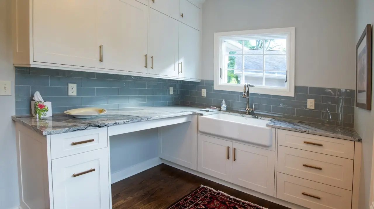 customer white countertops and blue subway tile in laundry room