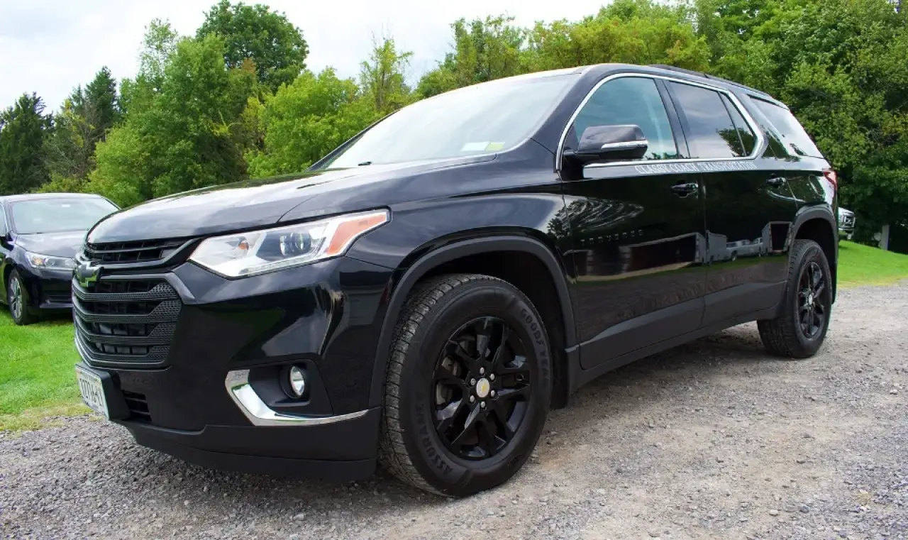 Black Chevrolet SUV parked on a gravel driveway.