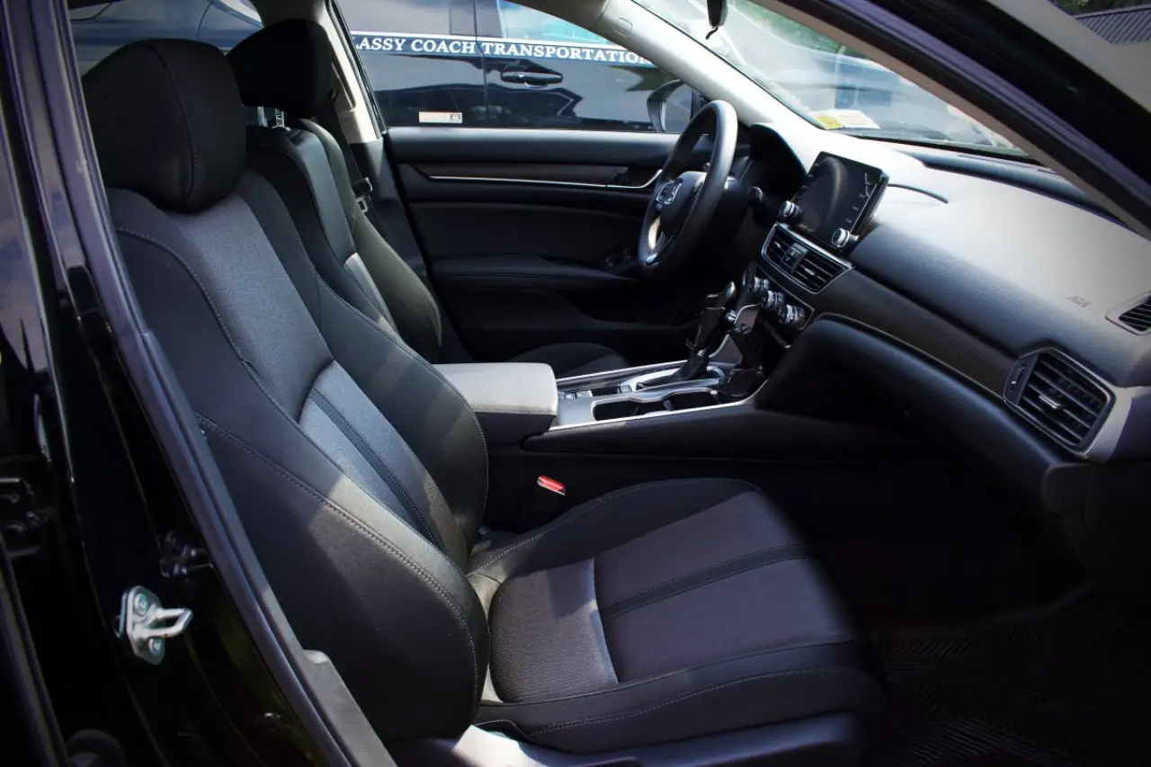 classy coach transportation black sedan front seat