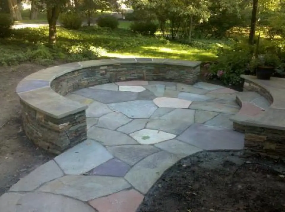 round stonework seated area in landscape design