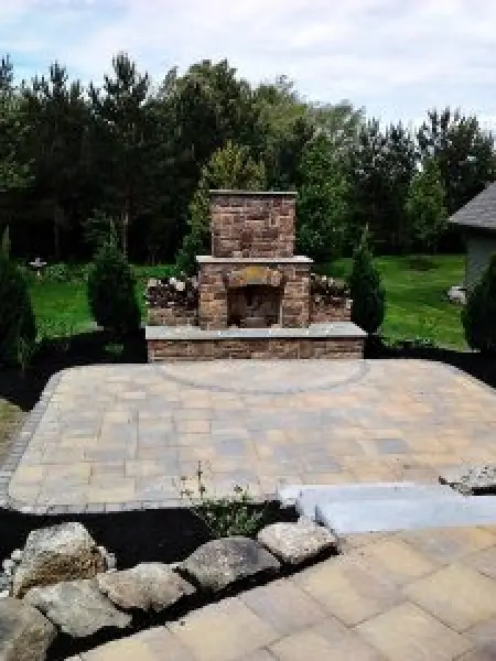 backyard with stone patio and fireplace