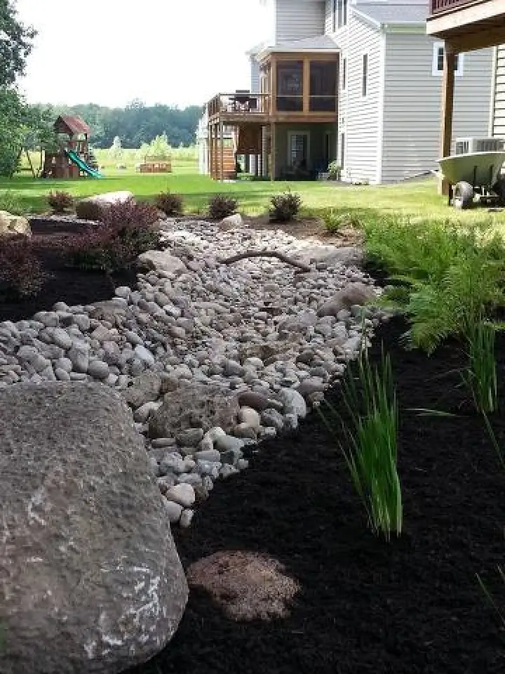 beautiful stone drainage in lawn landscape