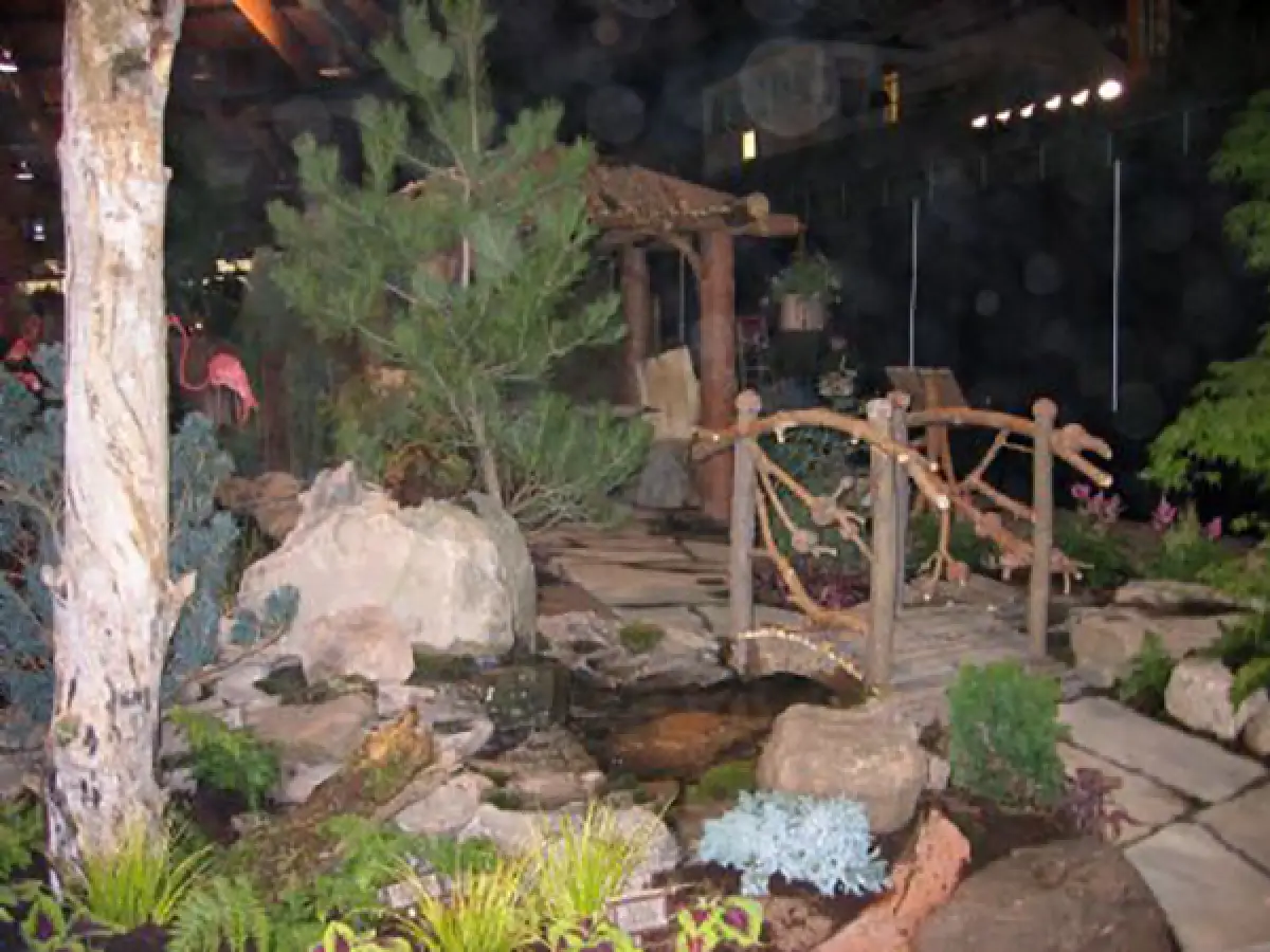 whimsical landscaping with stone pond, wood bridge and stone path