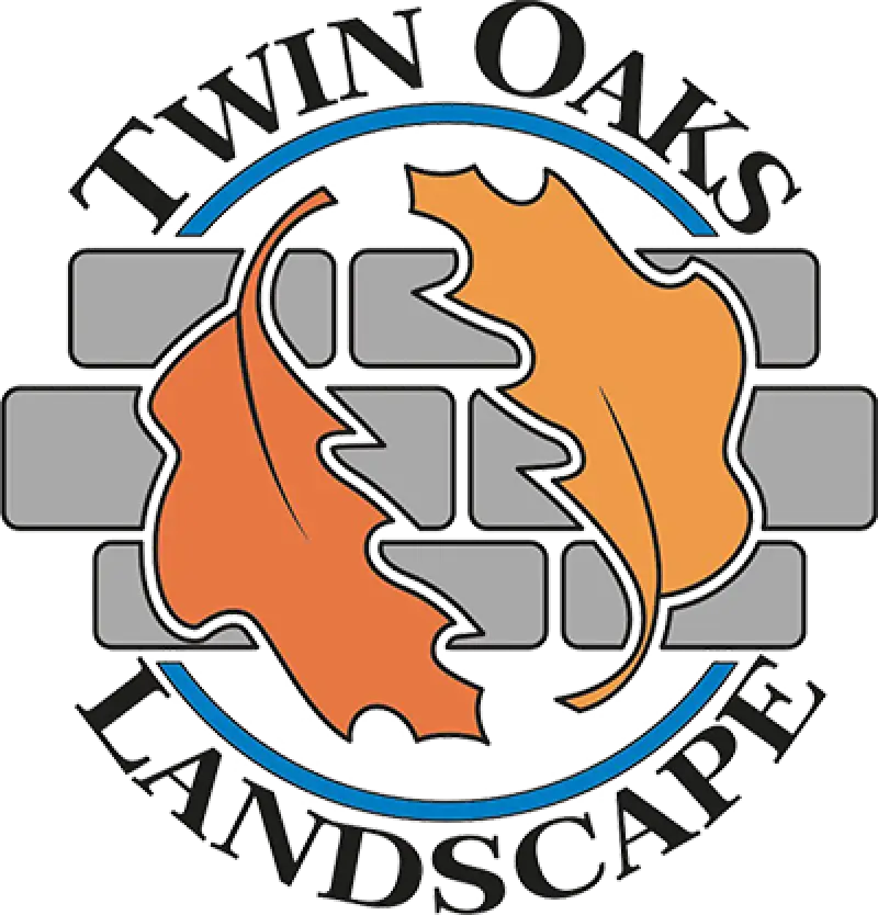 twin oaks logo with gray bricks and two orange leaves