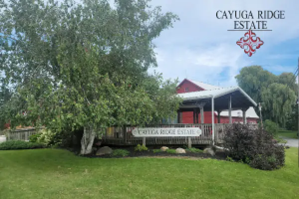 The Cayuga Ridge Estate Winery sign in front of the red barn tasting room