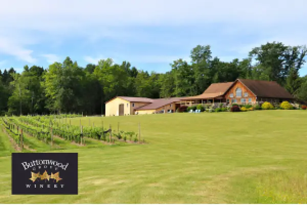The Buttonwood Grove tasting room and lawn seen across the vineyard