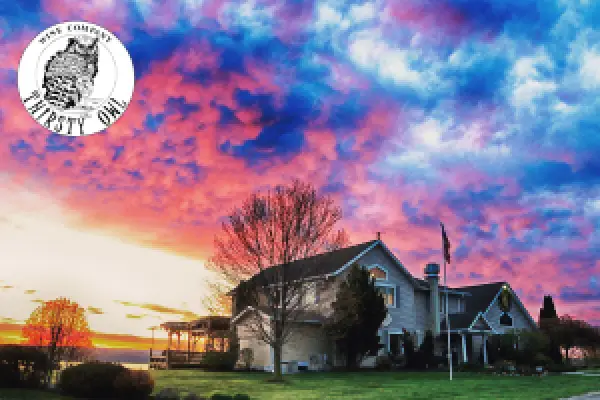 The Thirsty Owl tasting room at sunset beneath a pink and blue sky