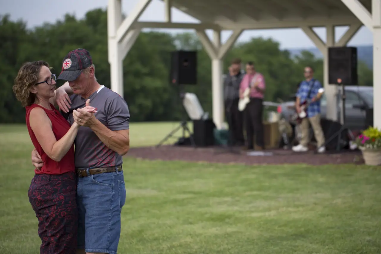 A couple dancing on the lawn while a band plays at Nautie Summer Nights