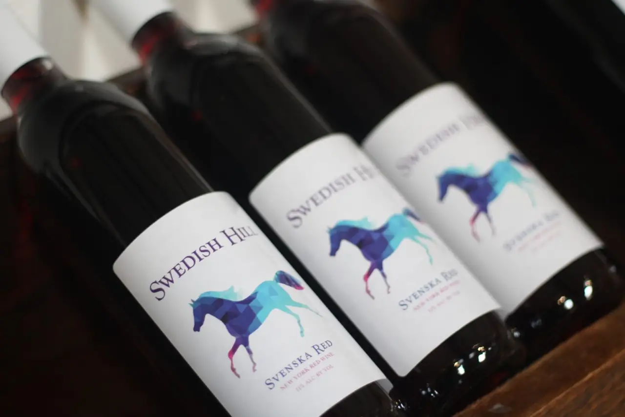 Three bottles of Swedish Hill Blue Waters wine with the horse label