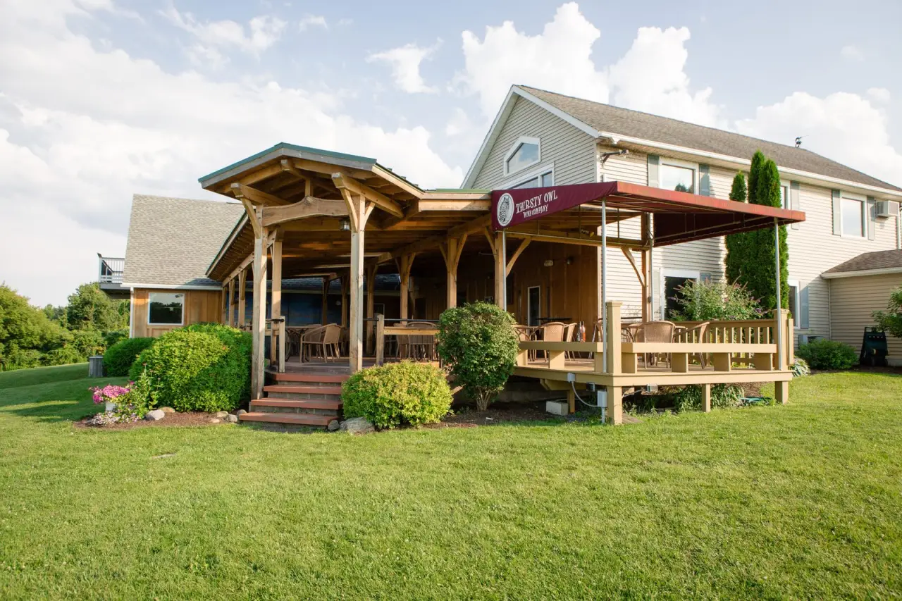 The Thirsty Owl bistro building with its covered porch and lawn