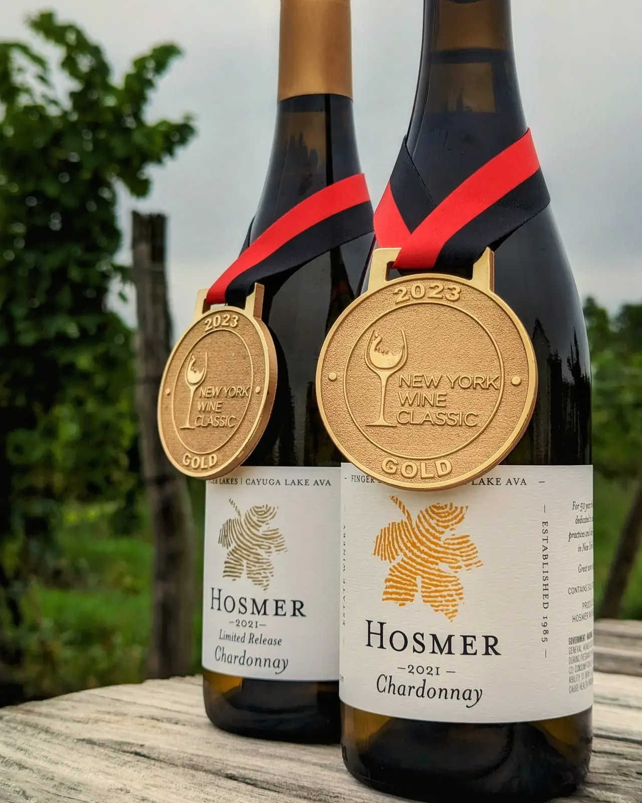 Two bottles of Hosmer Chardonnay wearing gold medals from a Finger Lakes wine competition