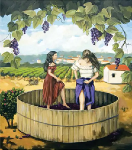 Two women stomp grapes in a wooden vat in a vineyard, with grapevines hanging above.
