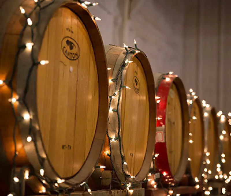 wooden barrels adorned with string lights, creating a festive atmosphere