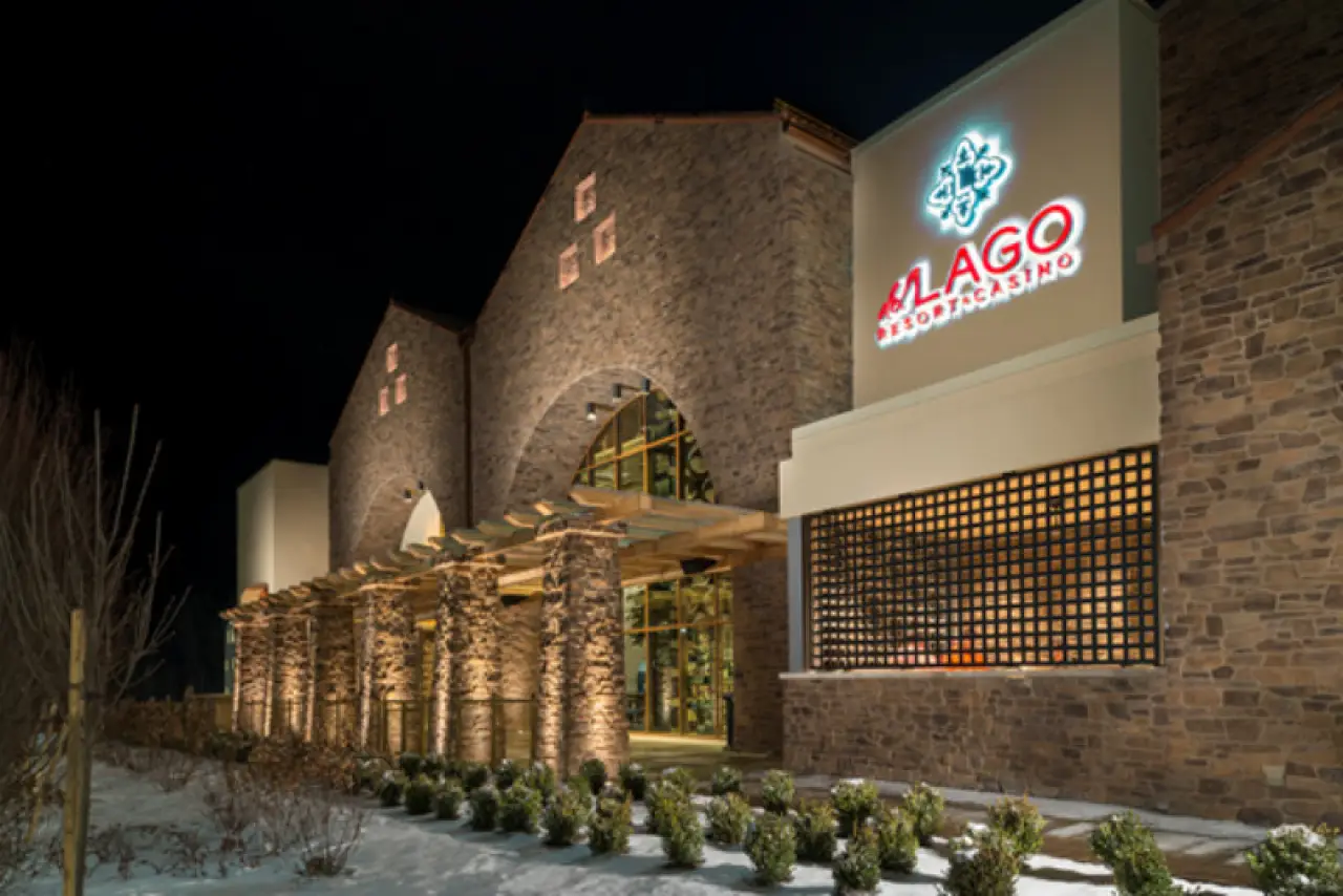 Night view of a stone building with Lago Resort Casino sign lit above the entrance.
