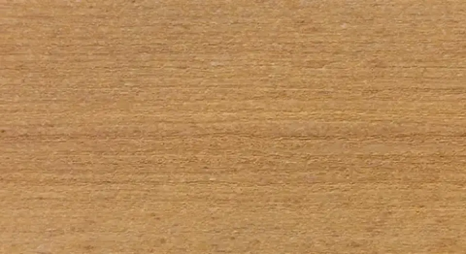 Close-up of a smooth, flat wooden surface with a light brown color and horizontal grain lines.