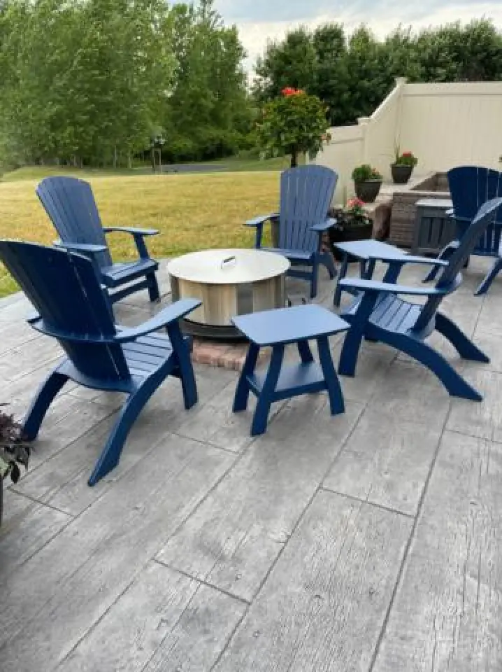blue adirondack chairs around a fire pit