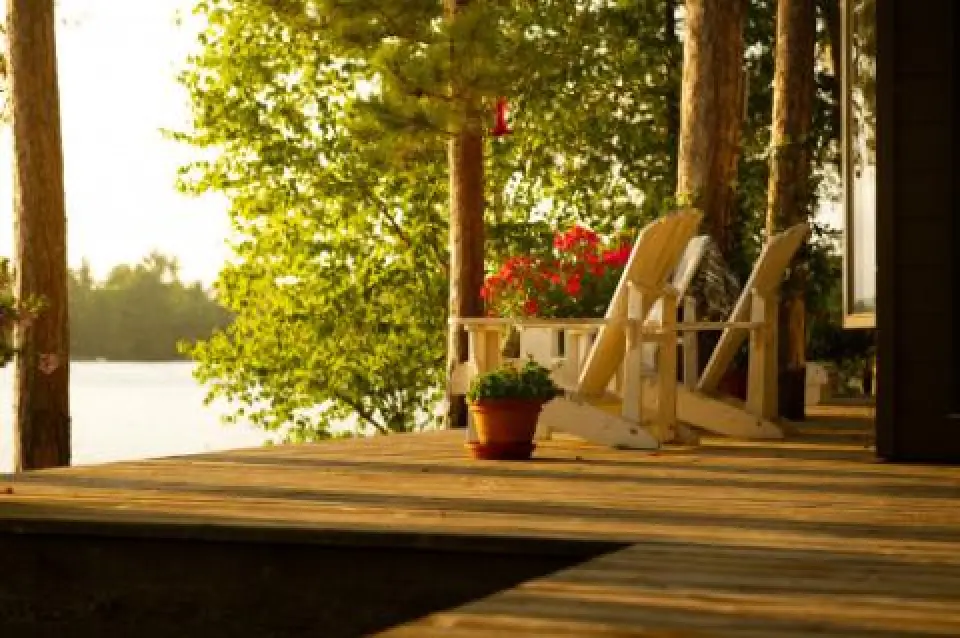 white blue adirondack chairs around a firepit on a porch
