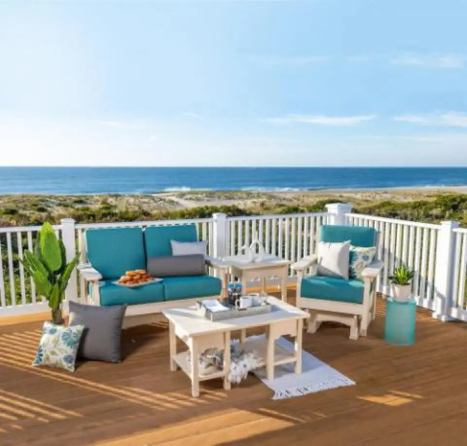 set of white adirondack furniture with blue cushions