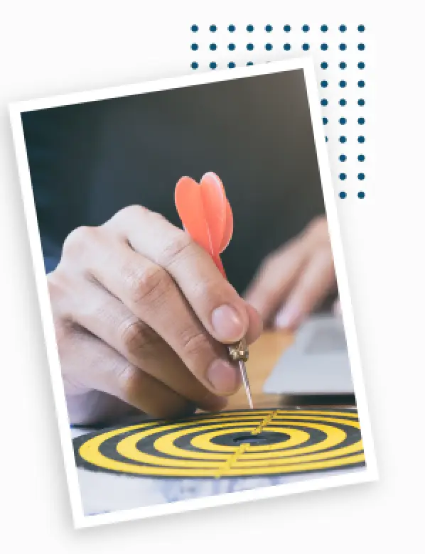 person holding dart above target