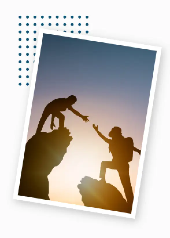 person reaching for another hiker on mountain