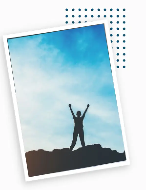 person with arms up on mountain