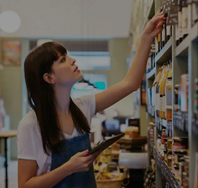 store worker checking inventory with a tablet