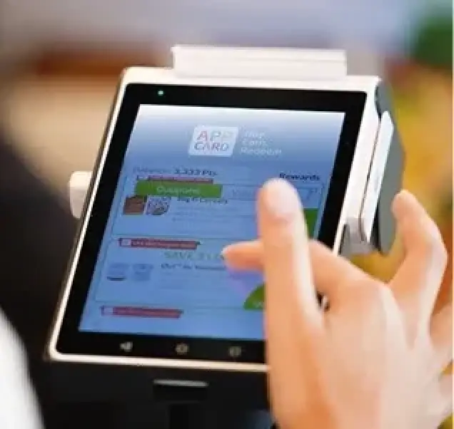 worker scrolling on app card on a store tablet