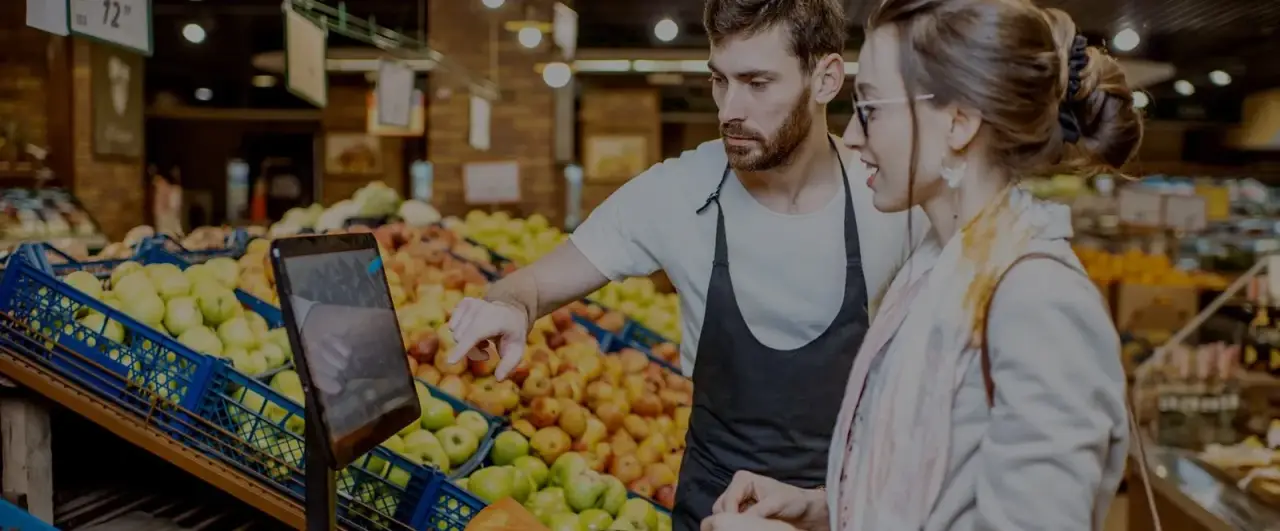 store worker man helping woman customer at grocery store