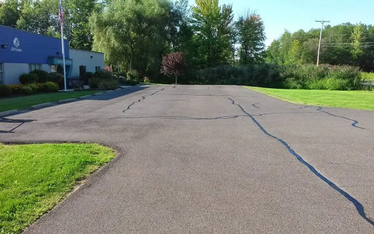 A paved parking lot in front of a Girl Scouts building