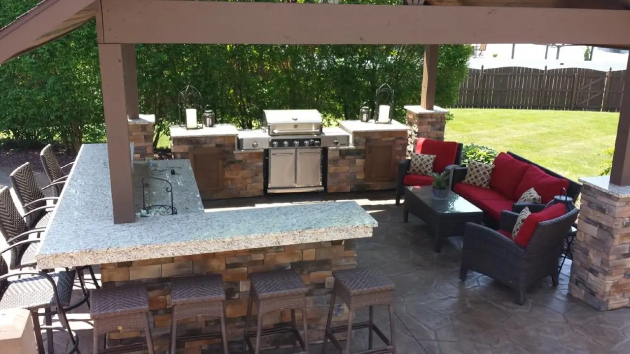 Backyard outdoor kitchen with grill and bar seating