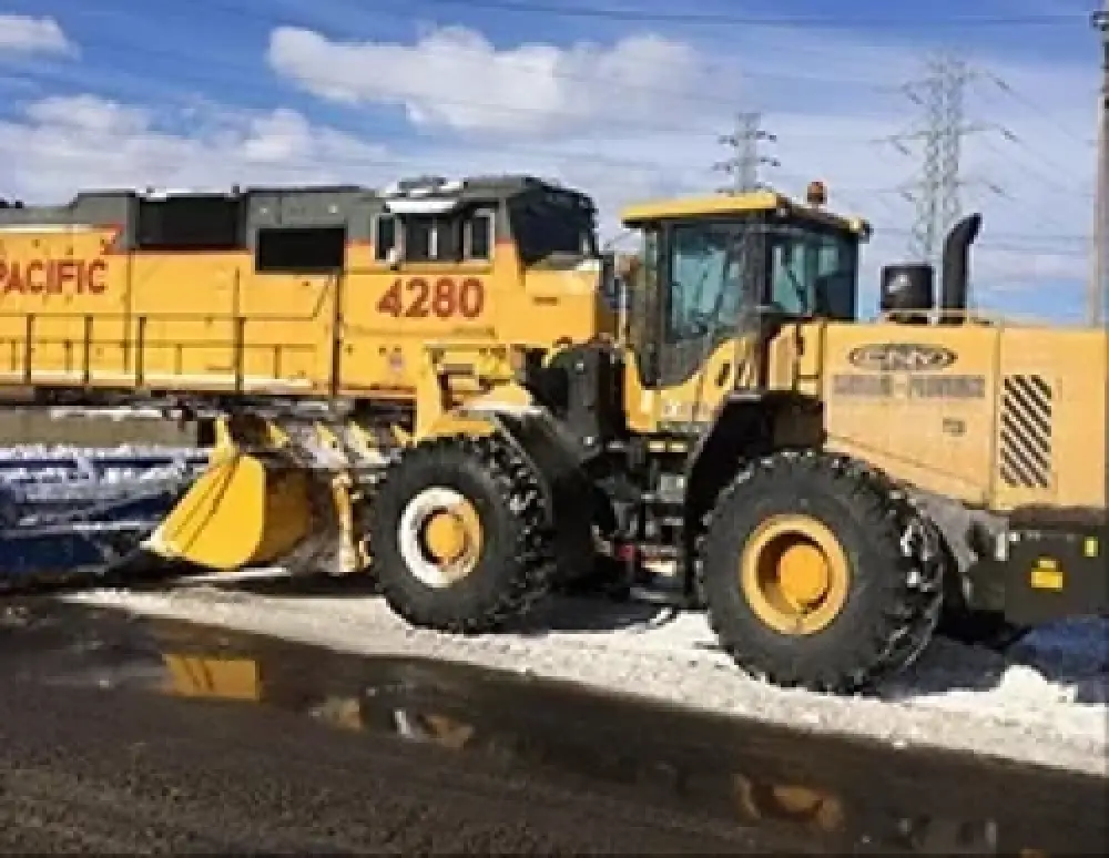 Commercial snow plow clearing a parking lot